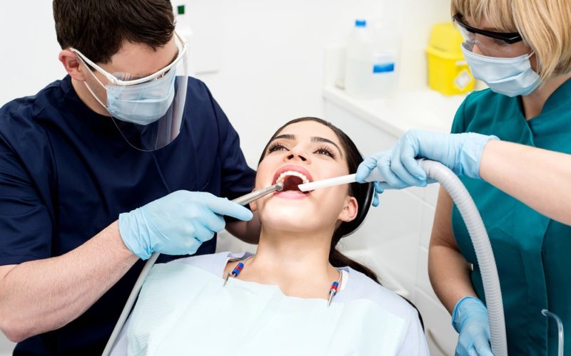 Orthodontist Treating A Patient